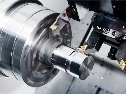 CNC turning machine cutting metal shaft on lathe