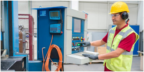 CNC machine operator following safety guidelines in factory